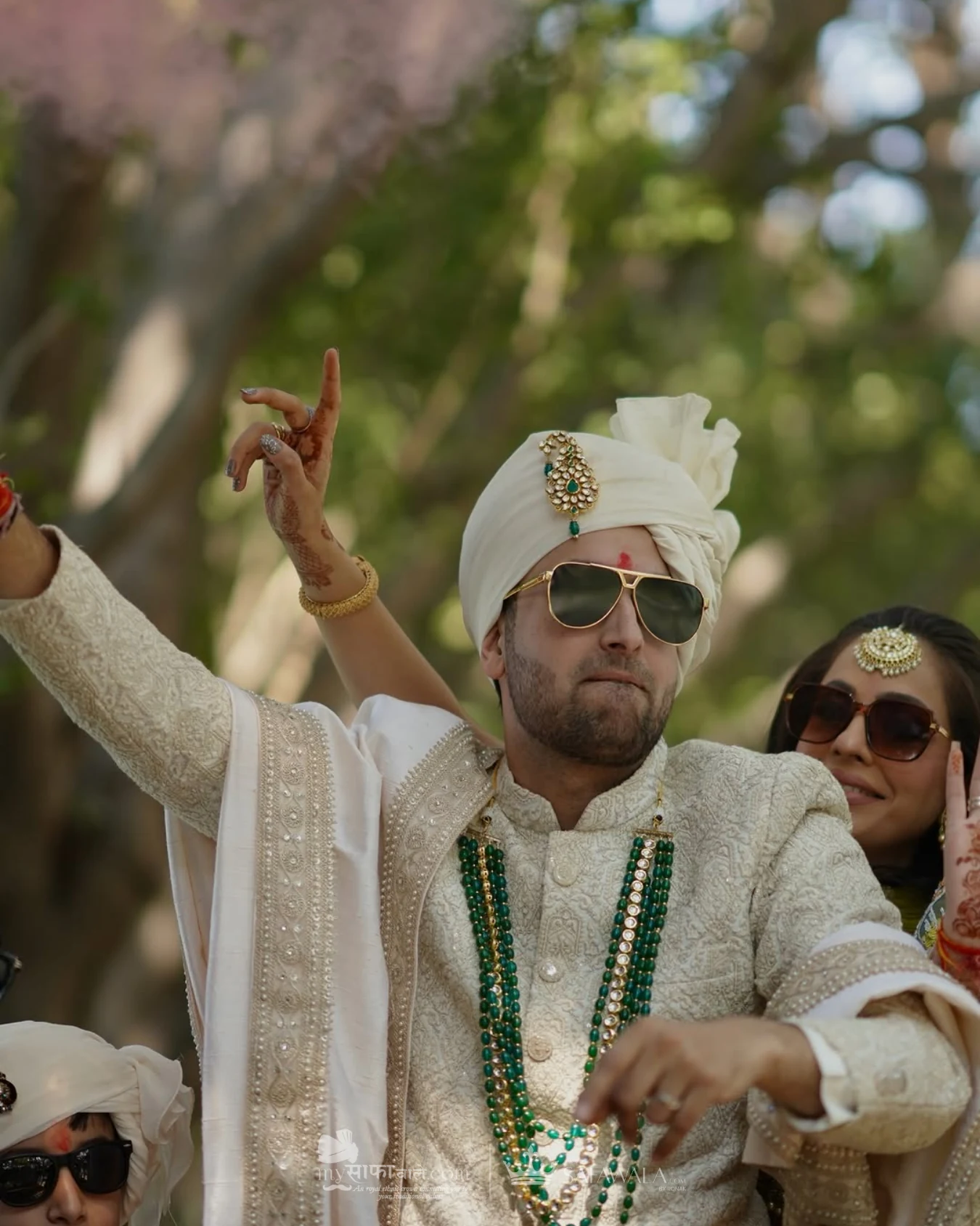 Groom in an ivory wedding safa with emerald jewellery for baraat safa package for destination weddings